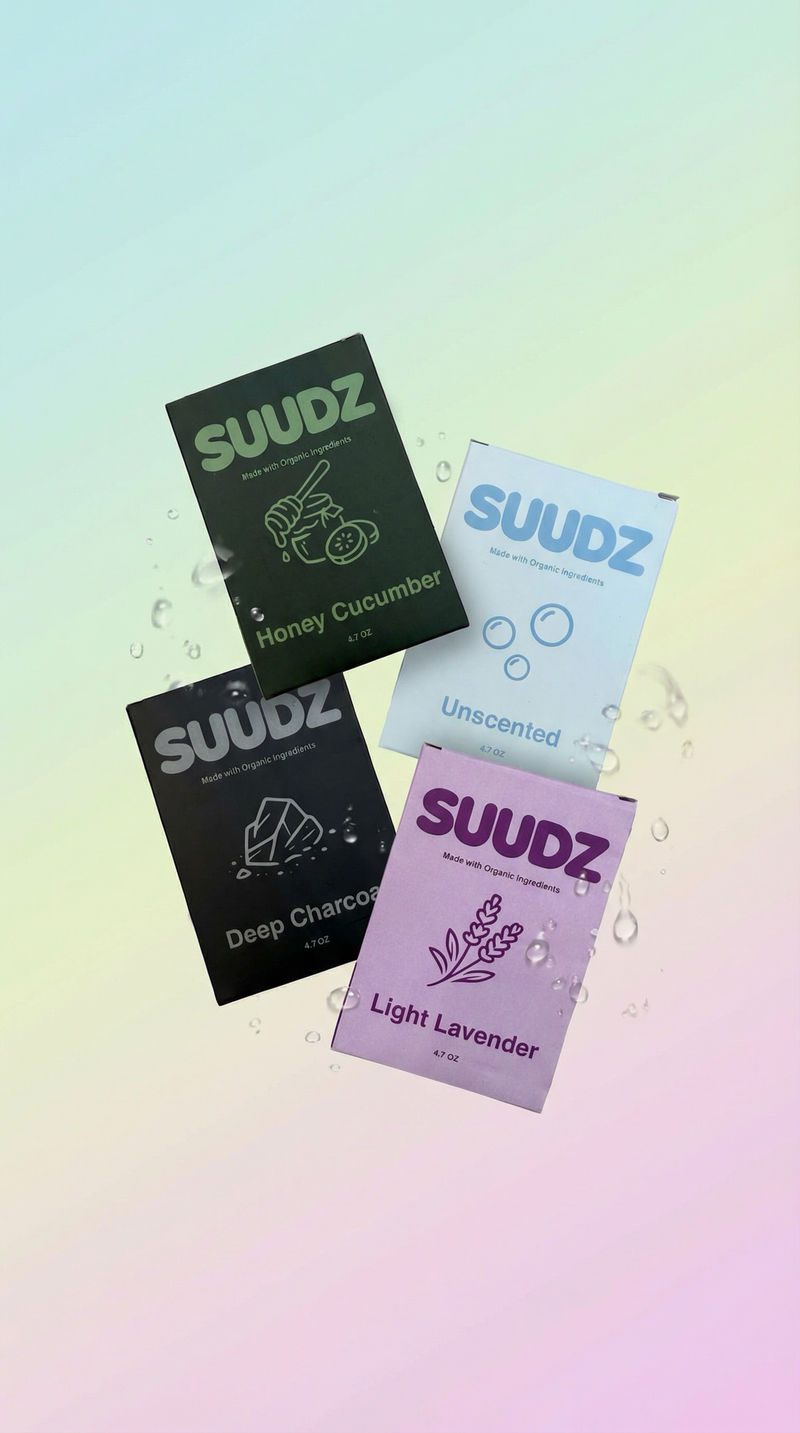 SUUDZ product packaging with different scents on a gradient background