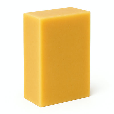 Yellow rectangular bar of soap on a white background